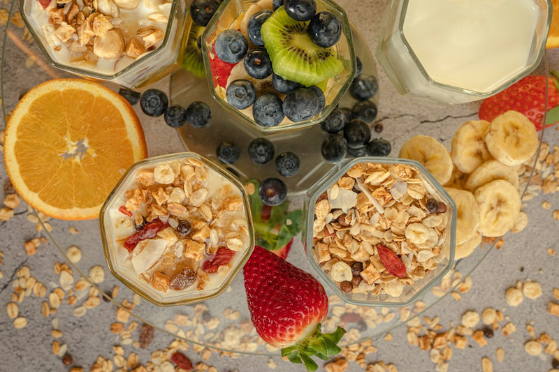 Breakfast parfaits with oats, yogurt, berries, banana and kiwi